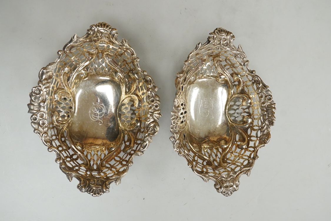 A pair of late Victorian pierced silver boat shaped bonbon dishes, with engraved monogram, by Charles Boyton II, London, 1897, length 16.4cm, 7.3oz.